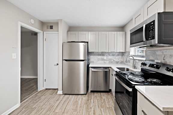 Kitchen with stainless steel refrigerator at Arbors at Smyrna, Smyrna, Georgia