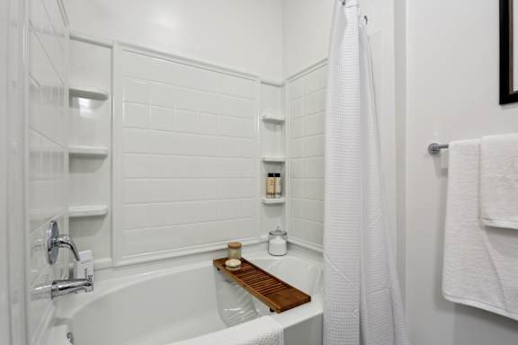 A white bathroom with a tub and a shower at Arcadia Cartersville Apartments, Cartersville, GA, 30121