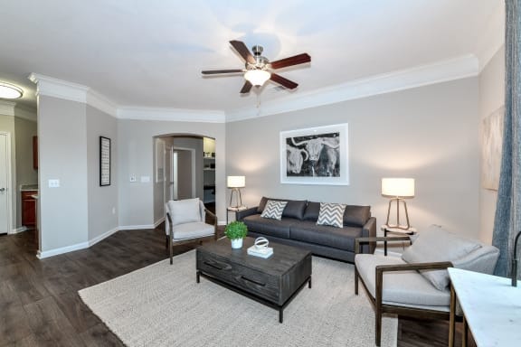 a living room with furniture and a ceiling fan  at Artesian on Westheimer, Houston, 77077