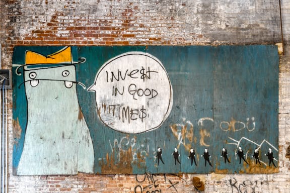 a mural on the side of a building that reads invest in good thinkers