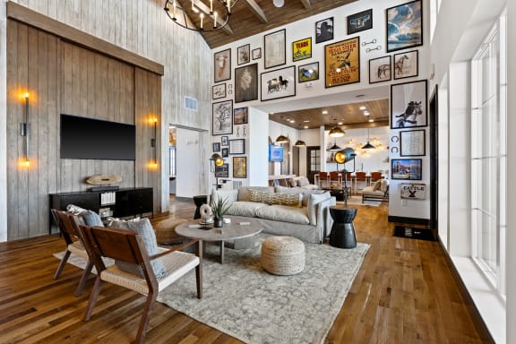 a living room filled with furniture and a large wall of photos