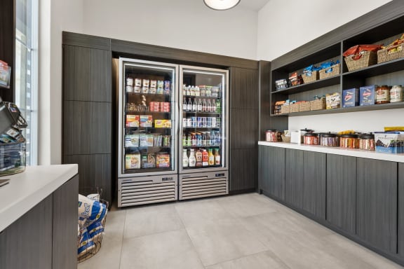 the pantry in the clubhouse has a large refrigerator and plenty of food