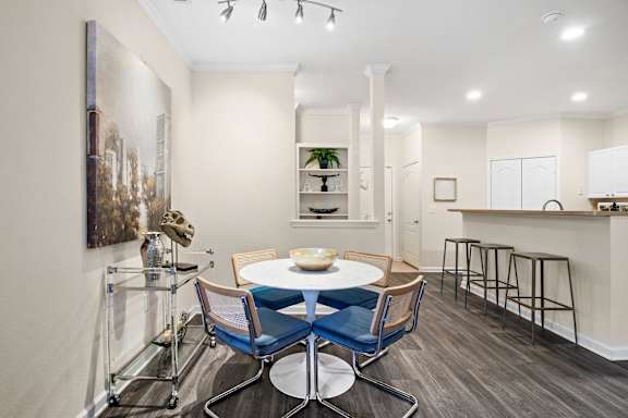 Open dining area with round table and breakfast bar at Alden Place at South Square Apartments, Durham