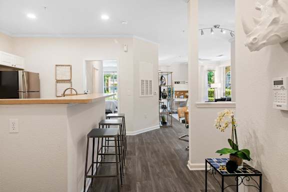 Open kitchen with breakfast bar and wood countertop at Alden Place at South Square Apartments, Durham, NC 27707