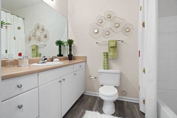 Bathroom with white vanity and decorative wall art at Alden Place at South Square Apartments, Durham, NC