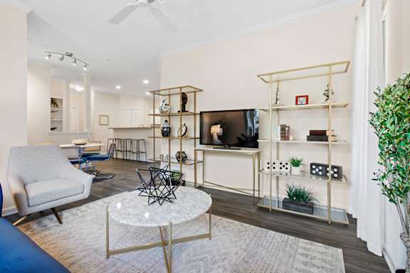 Living area with marble coffee table and entertainment center at Alden Place at South Square Apartments, Durham