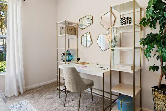 Home office with gold shelving and vanity desk at Alden Place at South Square Apartments, Durham, NC 27707