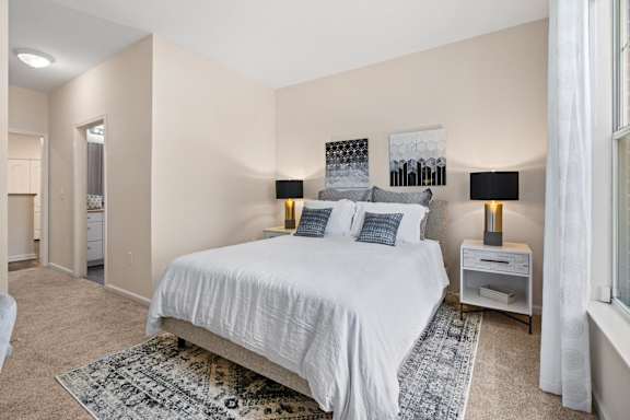 Bedroom with vaulted ceiling and matching nightstands at Alden Place at South Square Apartments, Durham, NC