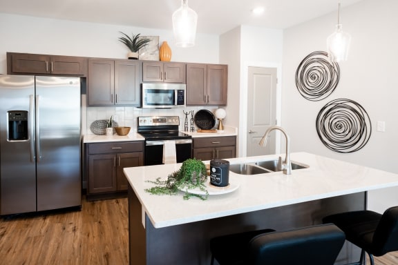 a kitchen with a large island and stainless steel appliances  at City Place, Memphis