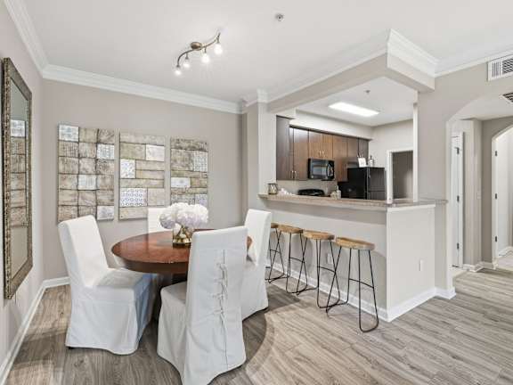 A modern kitchen with a dining table and chairs.