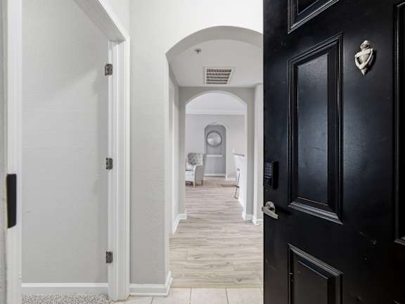 A black door with a silver handle is on the right side of the image.