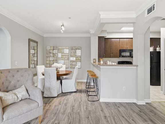 A modern kitchen with a dining table and chairs.