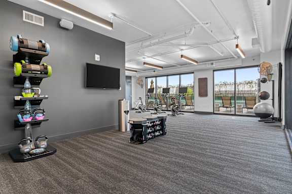 room with gym equipment and a television at the district flats apartments at Deca Apartments, Greenville, South Carolina