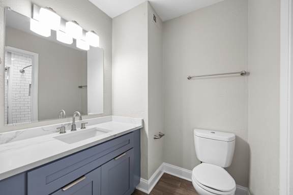 A white toilet sits next to a sink in a bathroom. at Dunwoody Glen, Atlanta, GA 30360