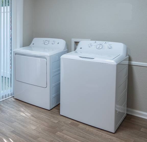 Two white washing machines with wooden floor at Dunwoody Glen, Atlanta, GA