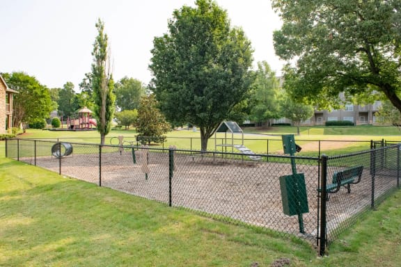 a fenced in dog park with a playground in the background at Appling Lakes, Tennessee, 38016
