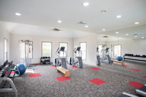 a spacious fitness center with treadmills and other exercise equipment at Appling Lakes, Cordova, TN