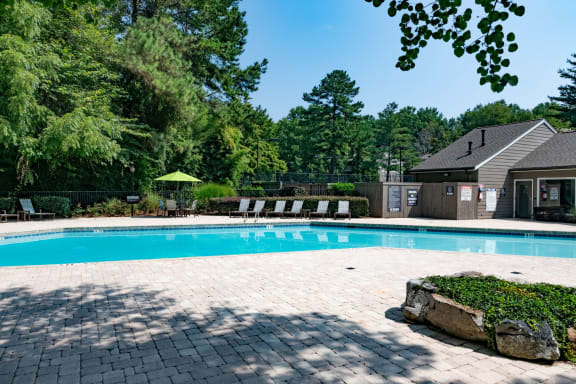 Swimming pool with a house and trees in the background at 1900 Rosemont, Roswell