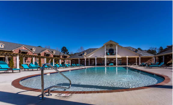 a resort style pool with lounge chairs around it  at Arlo Luxury homes Apartments, Little Rock, AR