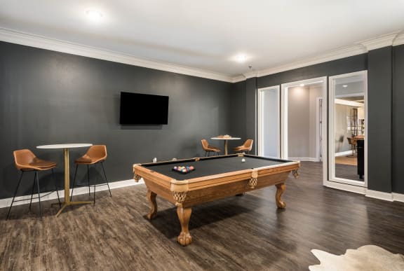 a games room with a pool table and a tv  at Arlo Luxury homes Apartments, Little Rock, Arkansas