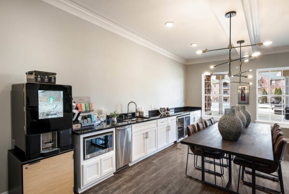 a kitchen and dining room with a table and a television  at Arlo Luxury homes Apartments, Little Rock, 72210