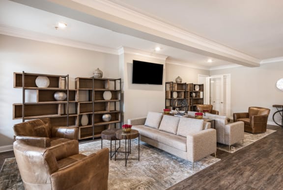 a living room with couches and chairs and a tv  at Arlo Luxury homes Apartments, Little Rock