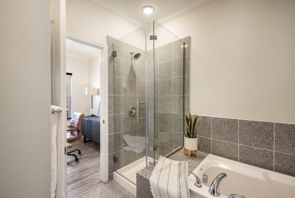 a bathroom with a shower and a tub &#xA0;at Arlo Luxury homes Apartments, Little Rock