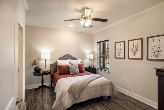 a bedroom with a bed and a ceiling fan &#xA0;at Arlo Luxury homes Apartments, Little Rock, AR