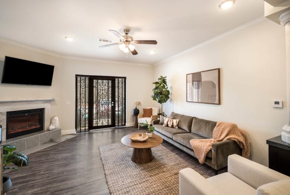 a living room with a couch and a fireplace &#xA0;at Arlo Luxury homes Apartments, Little Rock, Arkansas