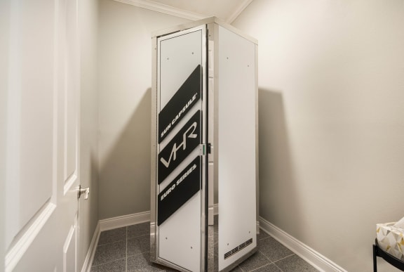 a small refrigerator in a small room in a room with white walls  at Arlo Luxury homes Apartments, Little Rock, 72210
