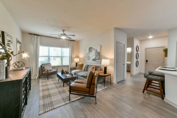 Gorgeous Modern Living Room with Two Tone Paint Colors and Wood Plank Vinyl Flooring (in Select Units) at Ashby at Ross Bridge, Hoover