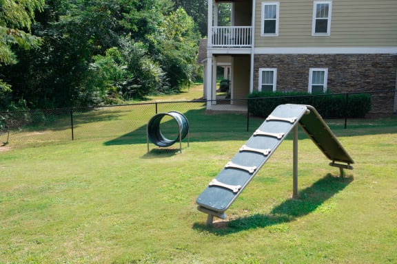 a seesaw in a yard with a house in the background at Ashby at Ross Bridge, Hoover, AL