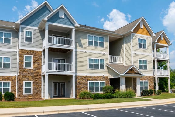 Bright Apartment Exteriors with Trees Inviting You Inside at Ashby at Ross Bridge, Hoover, AL 35226