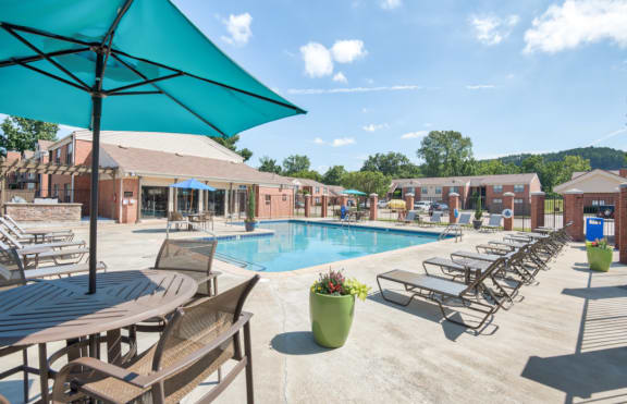 our apartments offer a swimming pool with tables and chairs at Brightwaters Apartments, Little Rock, Arkansas
