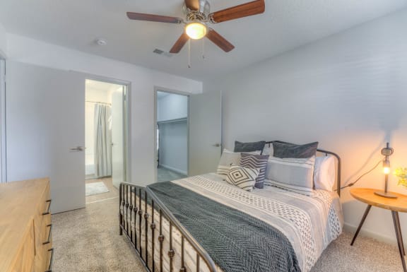 a bedroom with a bed and a ceiling fan&#xA0;at Brightwaters Apartments, Little Rock, AR