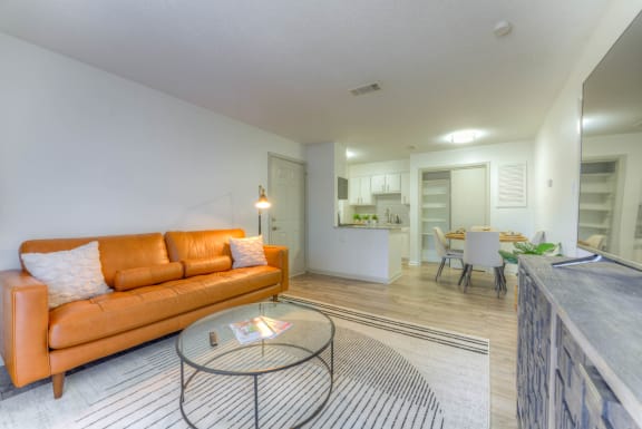 orange couch and a glass coffee table&#xA0;at Brightwaters Apartments, Little Rock, AR,72202