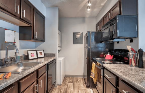 a kitchen with stainless steel appliances and granite counter tops&#xA0;at Brightwaters Apartments, Little Rock, 72202