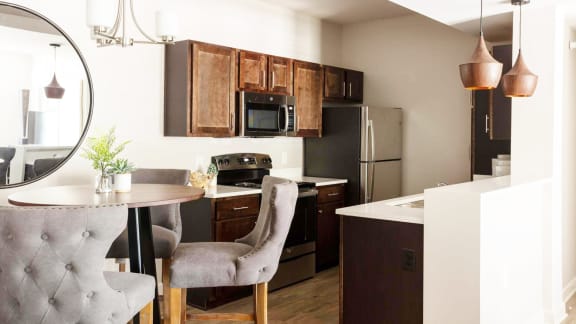 a kitchen and dining room with a table and chairs&#xA0;at Esplanade District Apartments, Little Rock, AR