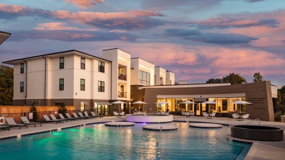 a large swimming pool in front of a hotel at Esplanade District Apartments, Little Rock, AR,72114
