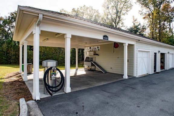 the front of a garage with a gas pump in the driveway at Legends at Chatham, Georgia, 31405