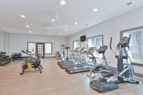 the gym is equipped with cardio equipment and weights at Legends at Chatham Apartments, Savannah