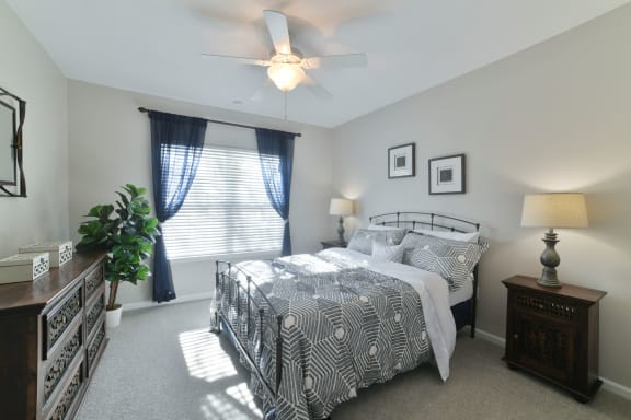 a bedroom with a bed and a ceiling fan at Legends at Chatham, Georgia