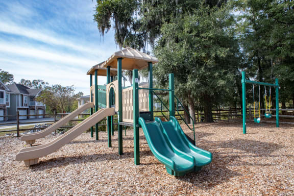 a playground with a play set and slides at Legends at Chatham, Savannah, GA