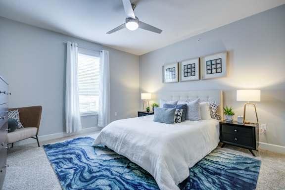 Bedroom with a Nightstand at McKenzie Park Apartments, Little Rock, AR