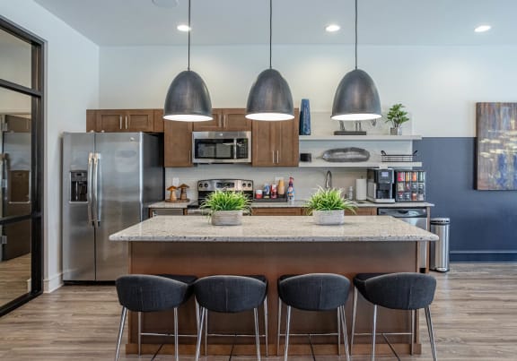 a kitchen with a large island with four chairs at The McKenzie Park Apartments, Little Rock, Arkansas