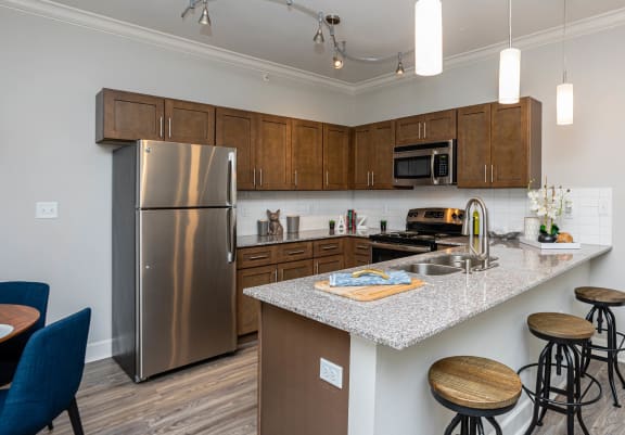 a kitchen with stainless steel appliances and granite counter tops at The McKenzie Park Apartments, Arkansas, 72223