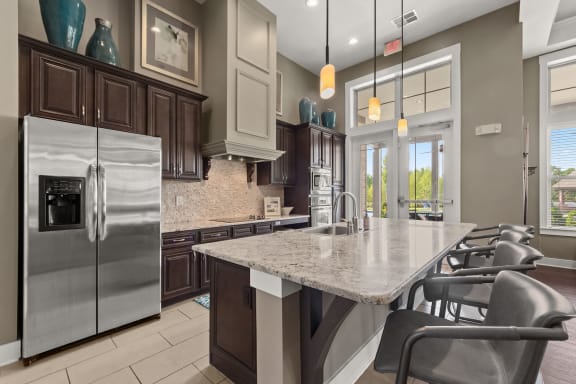 a kitchen with a marble counter top and stainless steel appliances at The Ridge at Chenal Valley, Arkansas, 72223