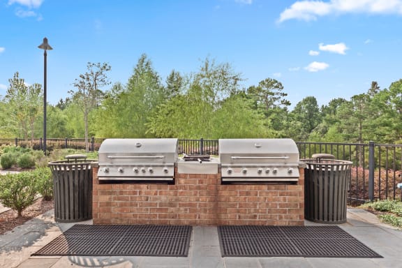 two gas bbqs sitting on a brick wall with two trash cans at The Ridge at Chenal Valley, Arkansas, 72223