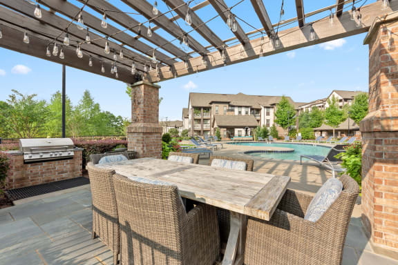 a patio with a table and chairs and a pool at The Ridge at Chenal Valley, Arkansas, 72223