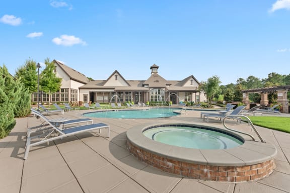 a pool with chairs and a spa in front of a house at The Ridge at Chenal Valley, Little Rock, 72223